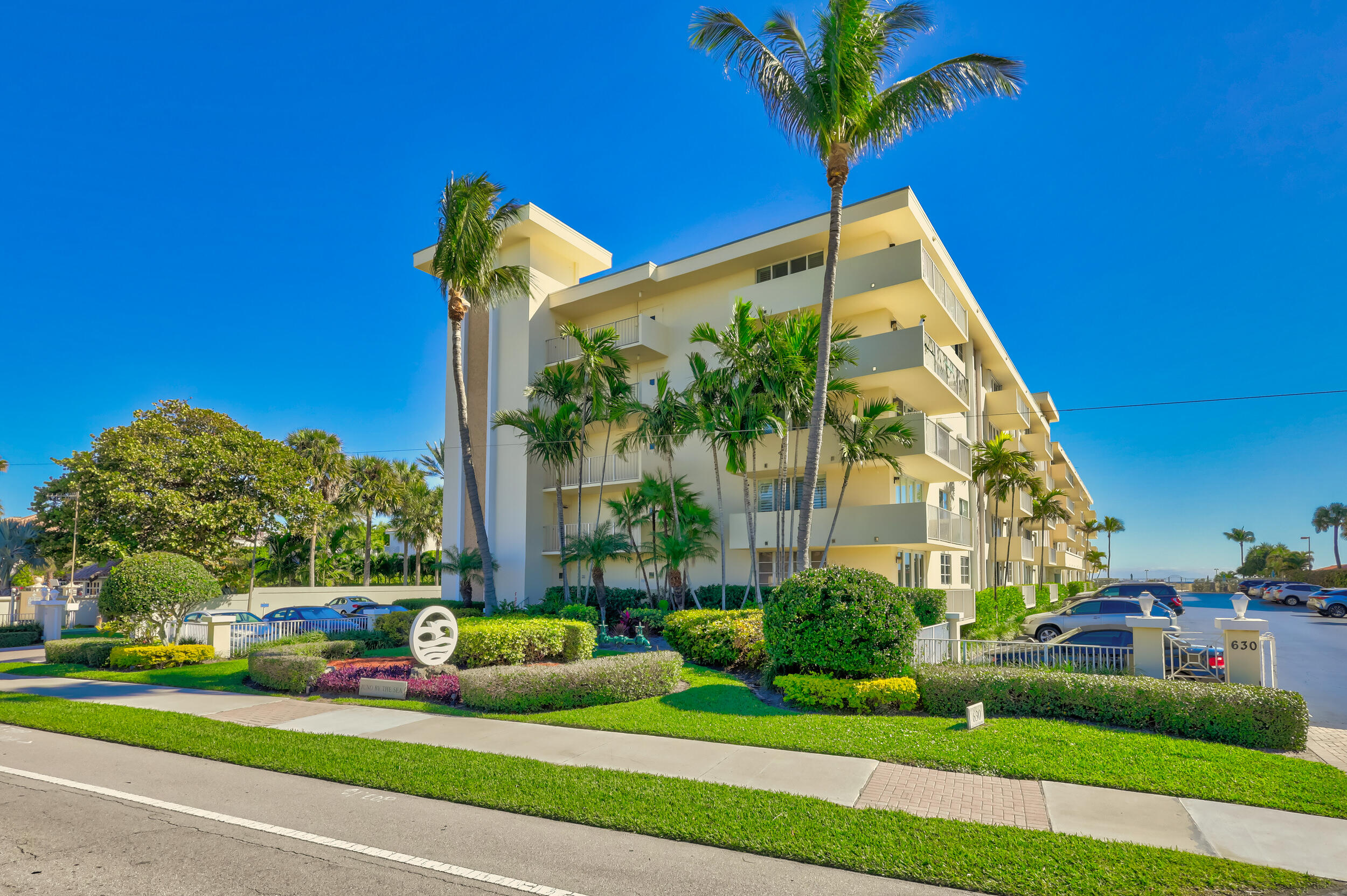 630 Ocean Drive, Unit 105 Juno Beach, FL 33408 - Photo 31 of 37 a front view of a house with a yard and potted plants