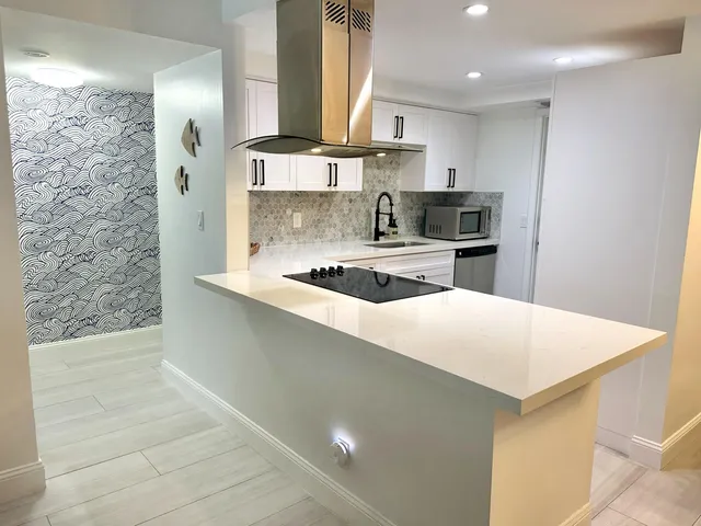 a kitchen with stainless steel appliances a refrigerator and a stove top oven