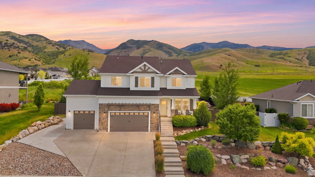 338 Windy Rdg Drive Smithfield, UT 84335 - Photo 1 of 65 Two-story residence with a stone and siding exterior, a multi-car driveway, and a terraced front yard