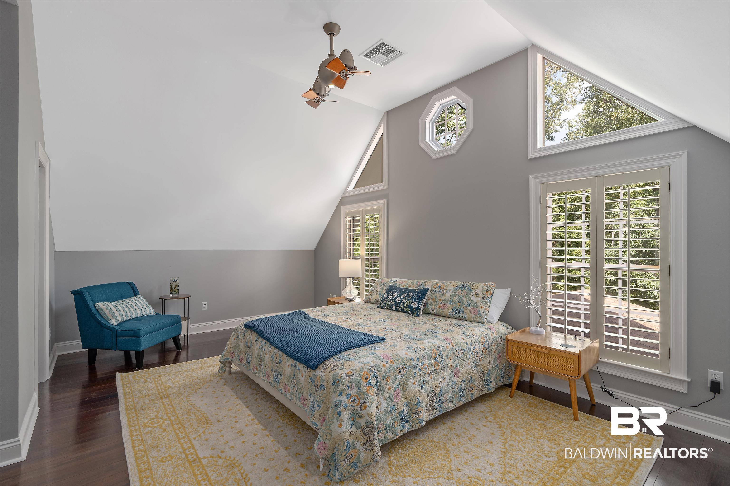 25591 Waterworld Road Robertsdale, AL 36567 - Photo 30 of 33 Bedroom with vaulted ceiling, dark hardwood / wood-style flooring, and multiple windows