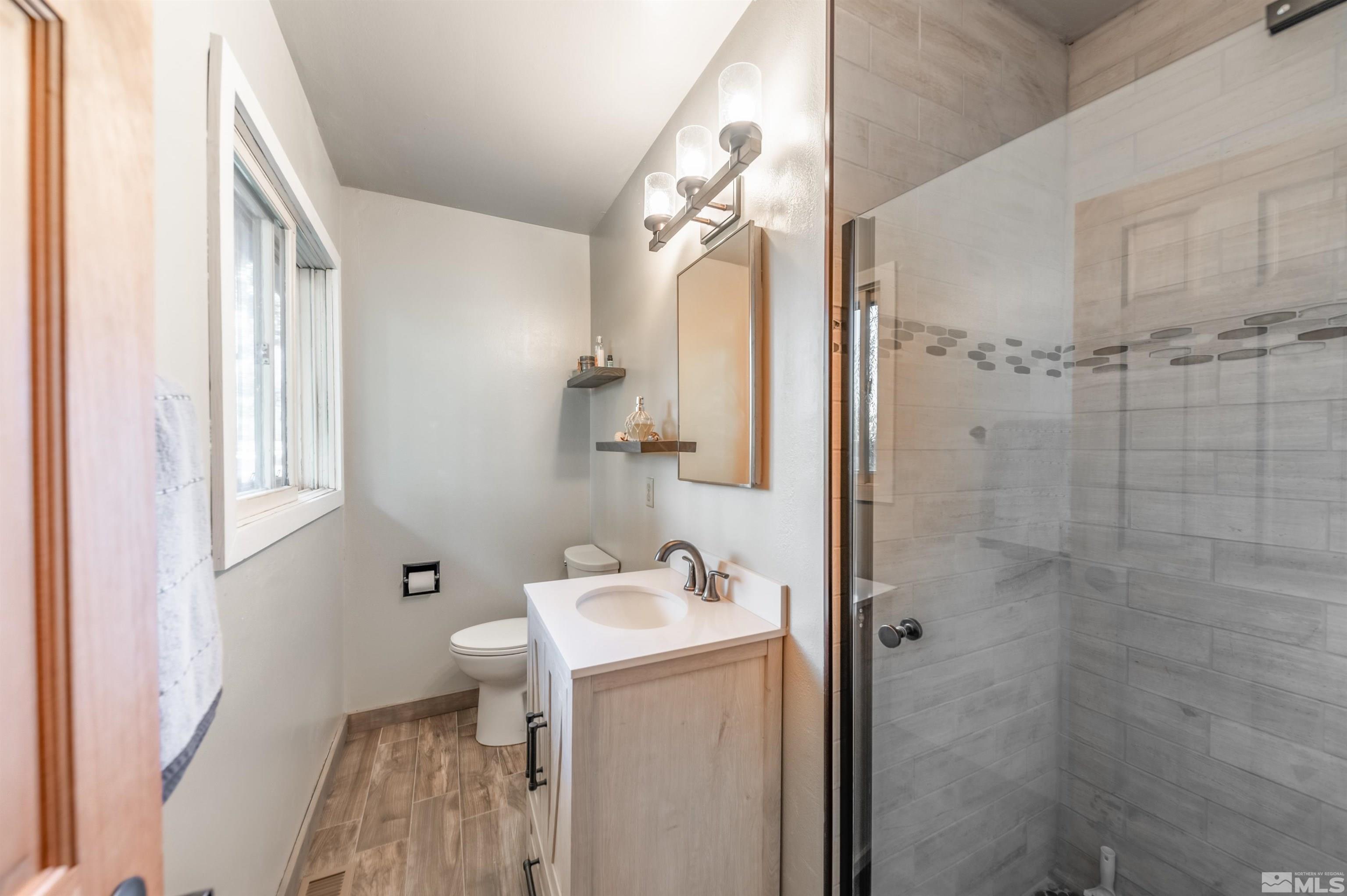9820 Dixon Lane Reno, NV 89511 - Photo 14 of 40 a bathroom with a sink a toilet and shower