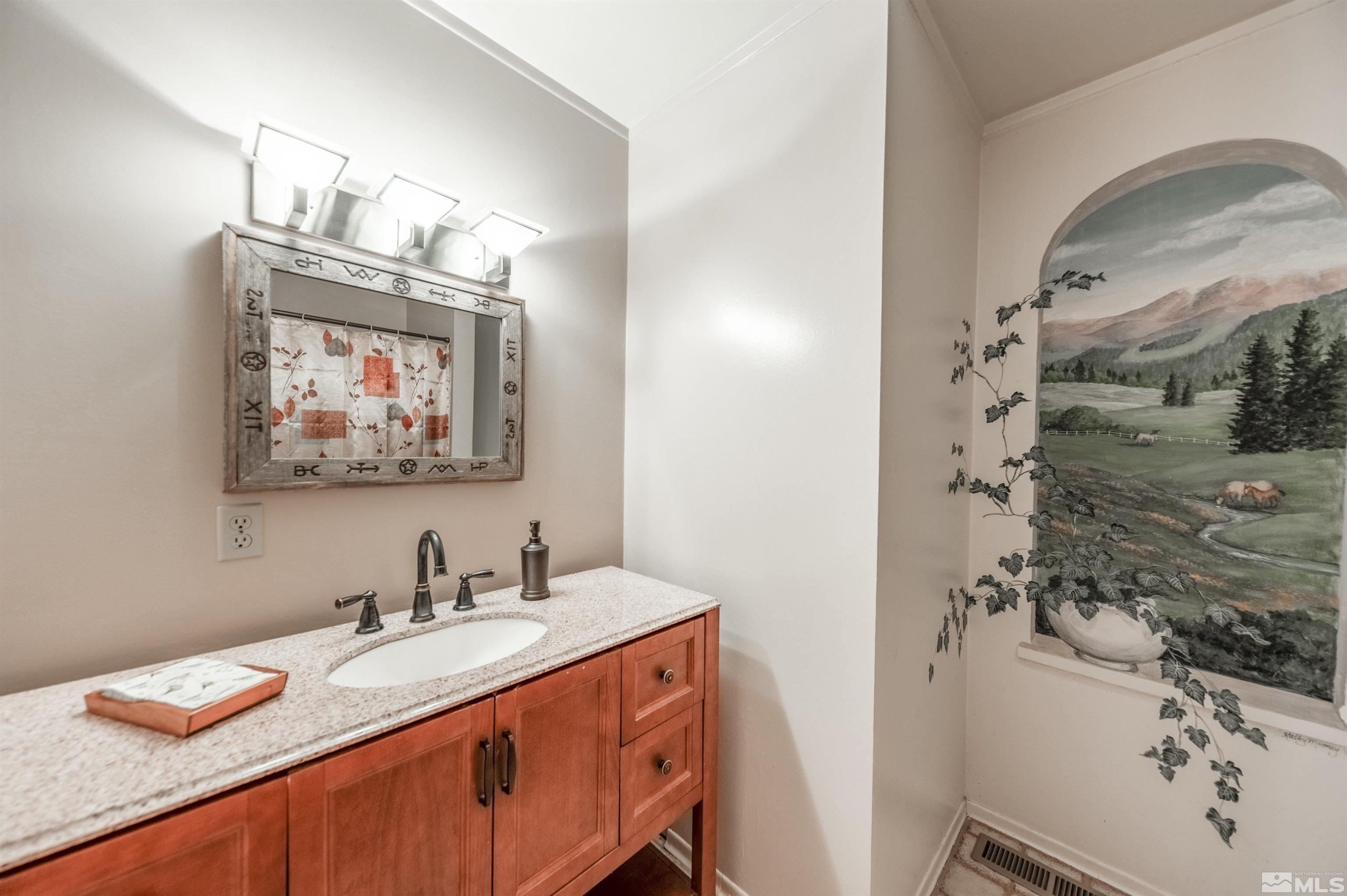 9820 Dixon Lane Reno, NV 89511 - Photo 16 of 40 a bathroom with a granite countertop sink a mirror and shower