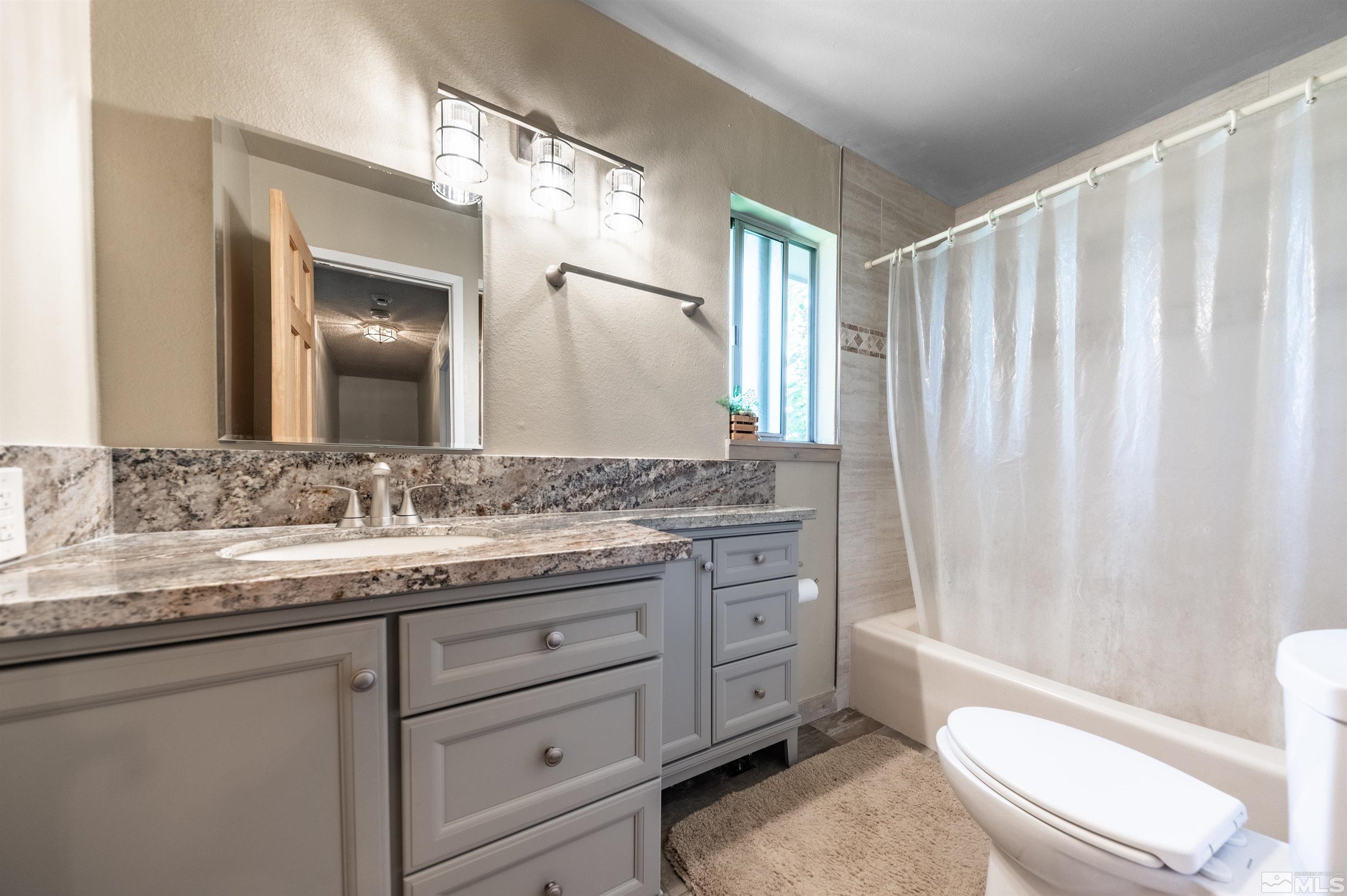 9820 Dixon Lane Reno, NV 89511 - Photo 19 of 40 a bathroom with a granite countertop sink toilet and shower
