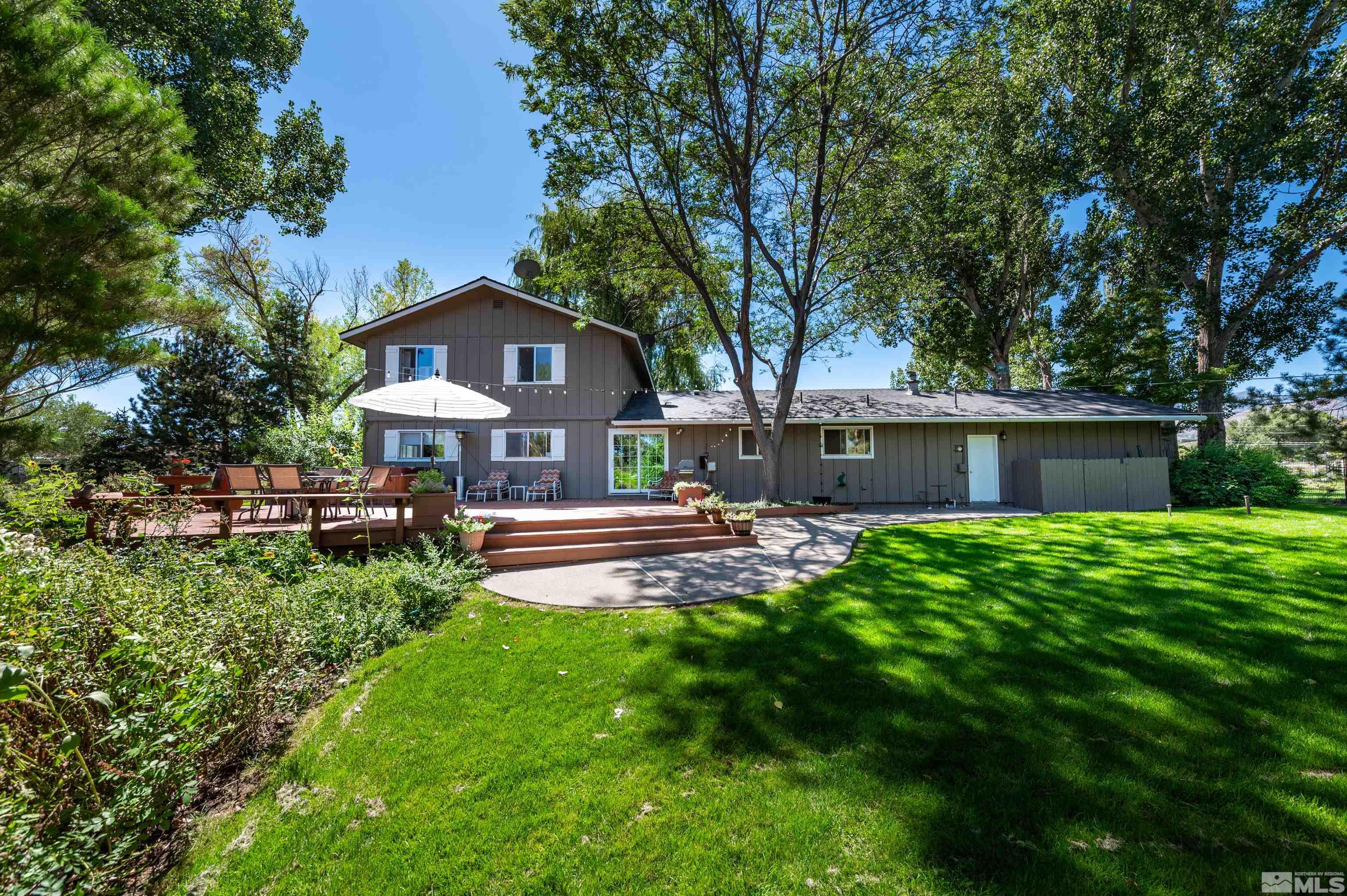 9820 Dixon Lane Reno, NV 89511 - Photo 23 of 40 a view of a house with a yard and a large tree