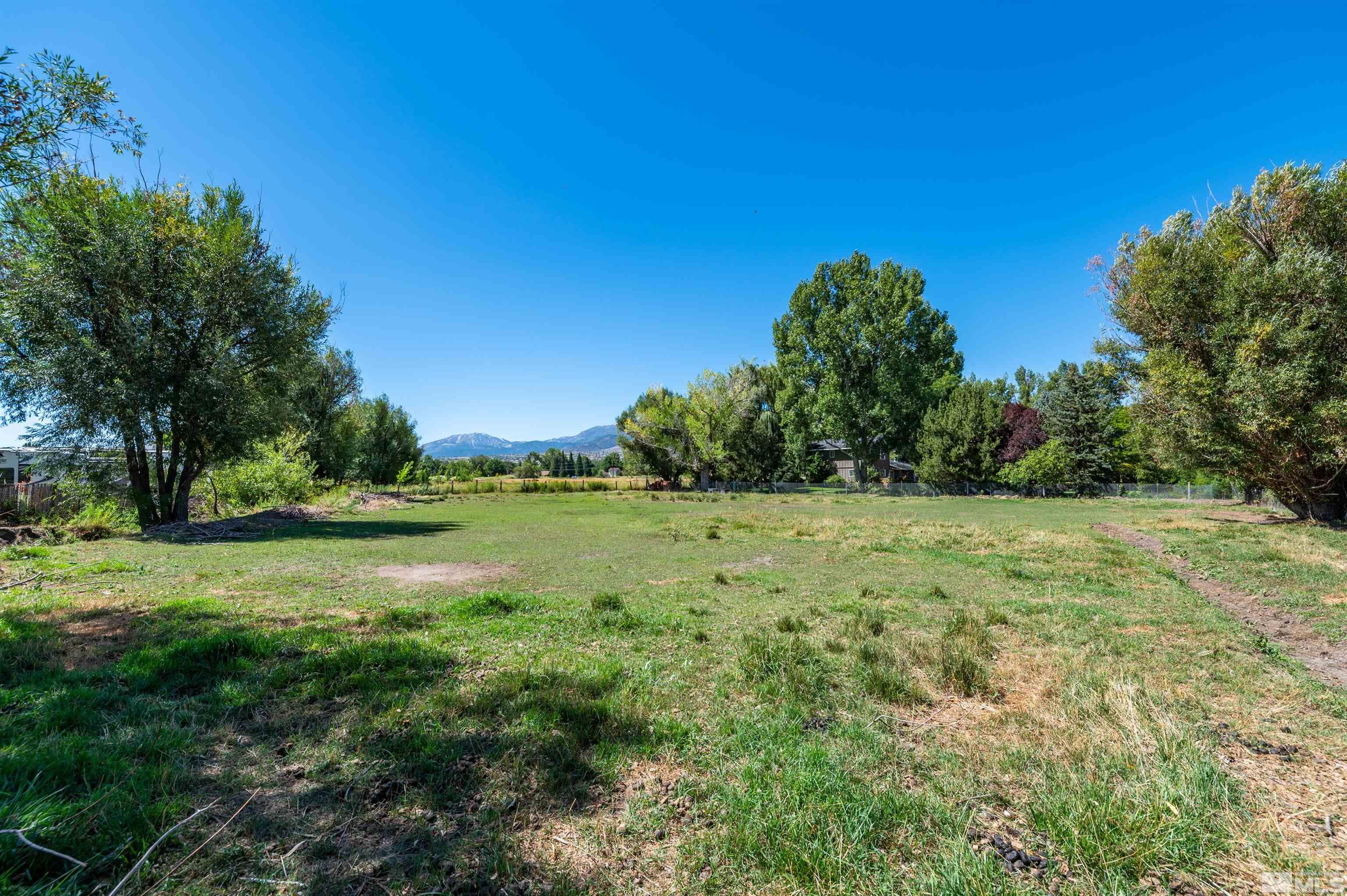 9820 Dixon Lane Reno, NV 89511 - Photo 40 of 40 a view of a green field with wooden fence