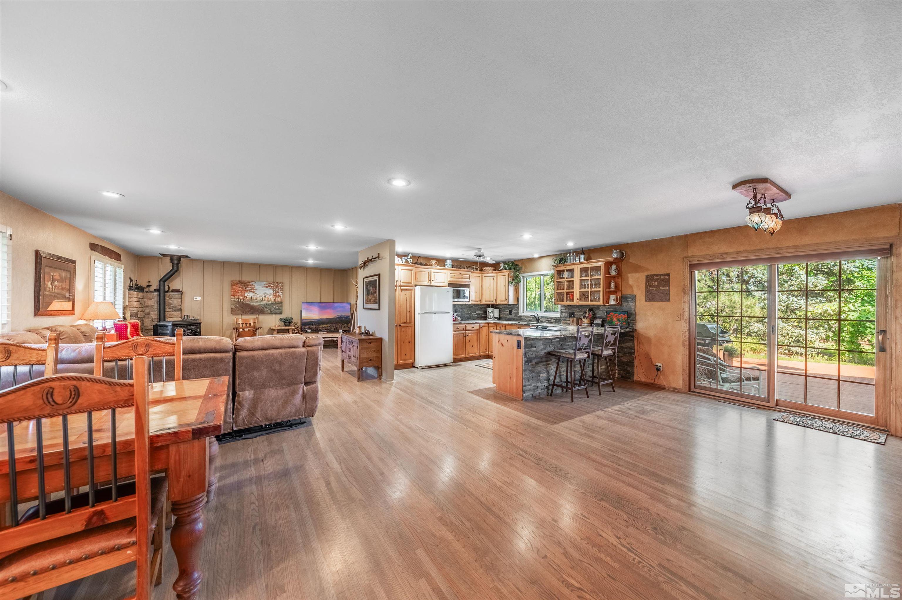 9820 Dixon Lane Reno, NV 89511 - Photo 5 of 40 a living room with furniture and a large window with kitchen view