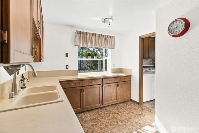 a kitchen with a sink and a stove top oven