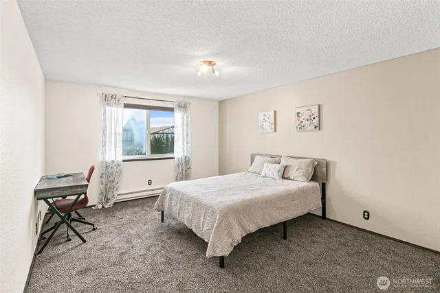 a bedroom with a bed and a table in it