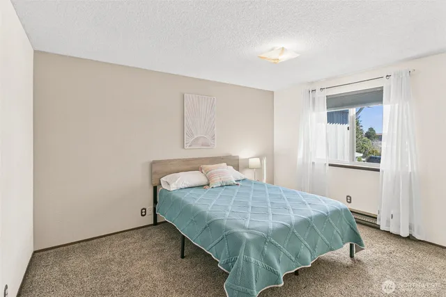 a bedroom with a bed and a window