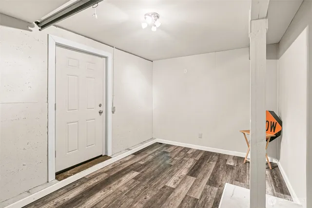 a view of water heater room with wooden floor