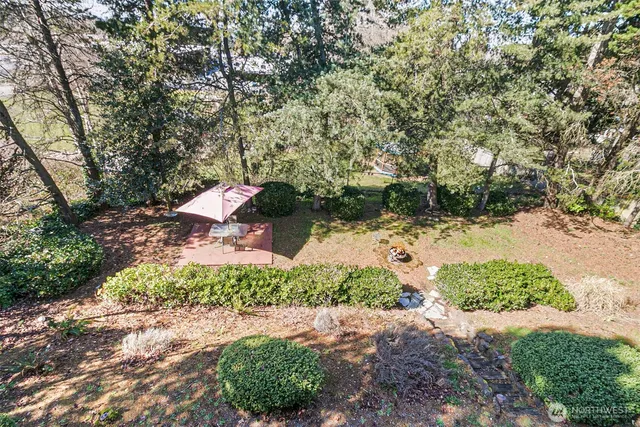 a front view of a house with a yard and shrubs