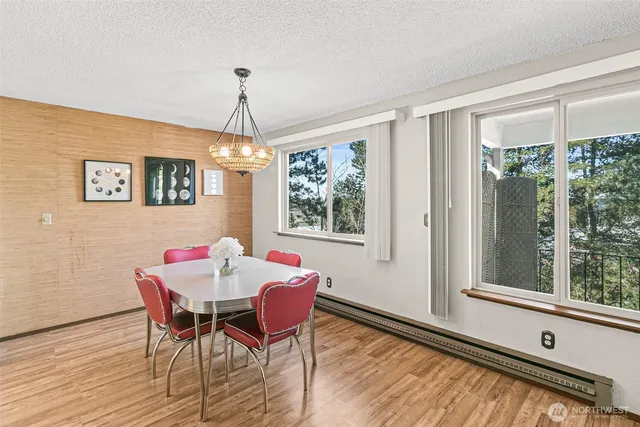 a dining room with furniture a chandelier and wooden floor