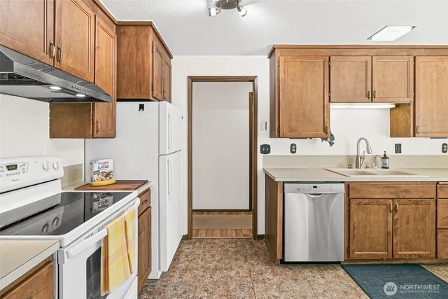 a kitchen with a sink stove and refrigerator