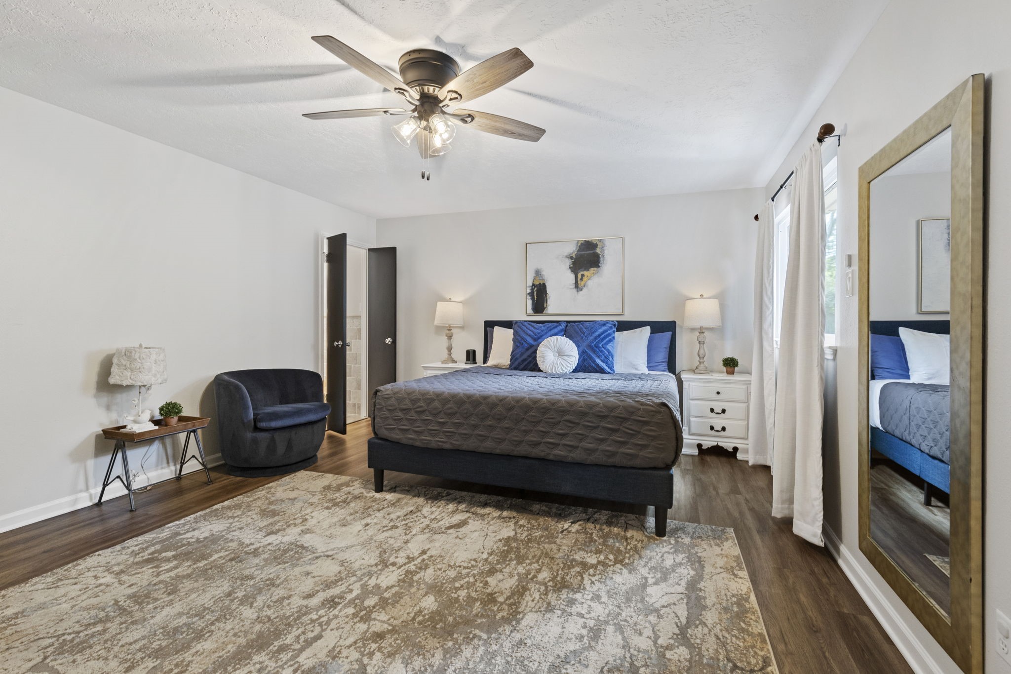 623 Hickory Ridge Drive Shenandoah, TX 77381 - Photo 19 of 26 a bedroom with a bed and a chandelier