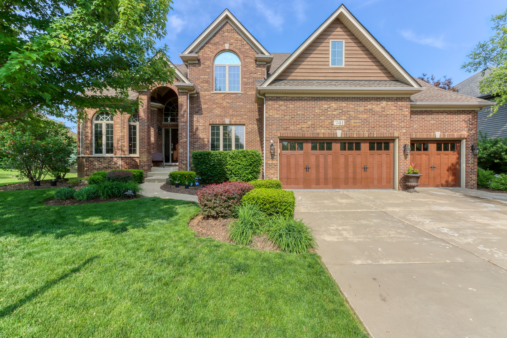 741 Merrill New Road Sugar Grove, IL 60554 - Photo 1 of 42 a front view of a house with a yard and garage