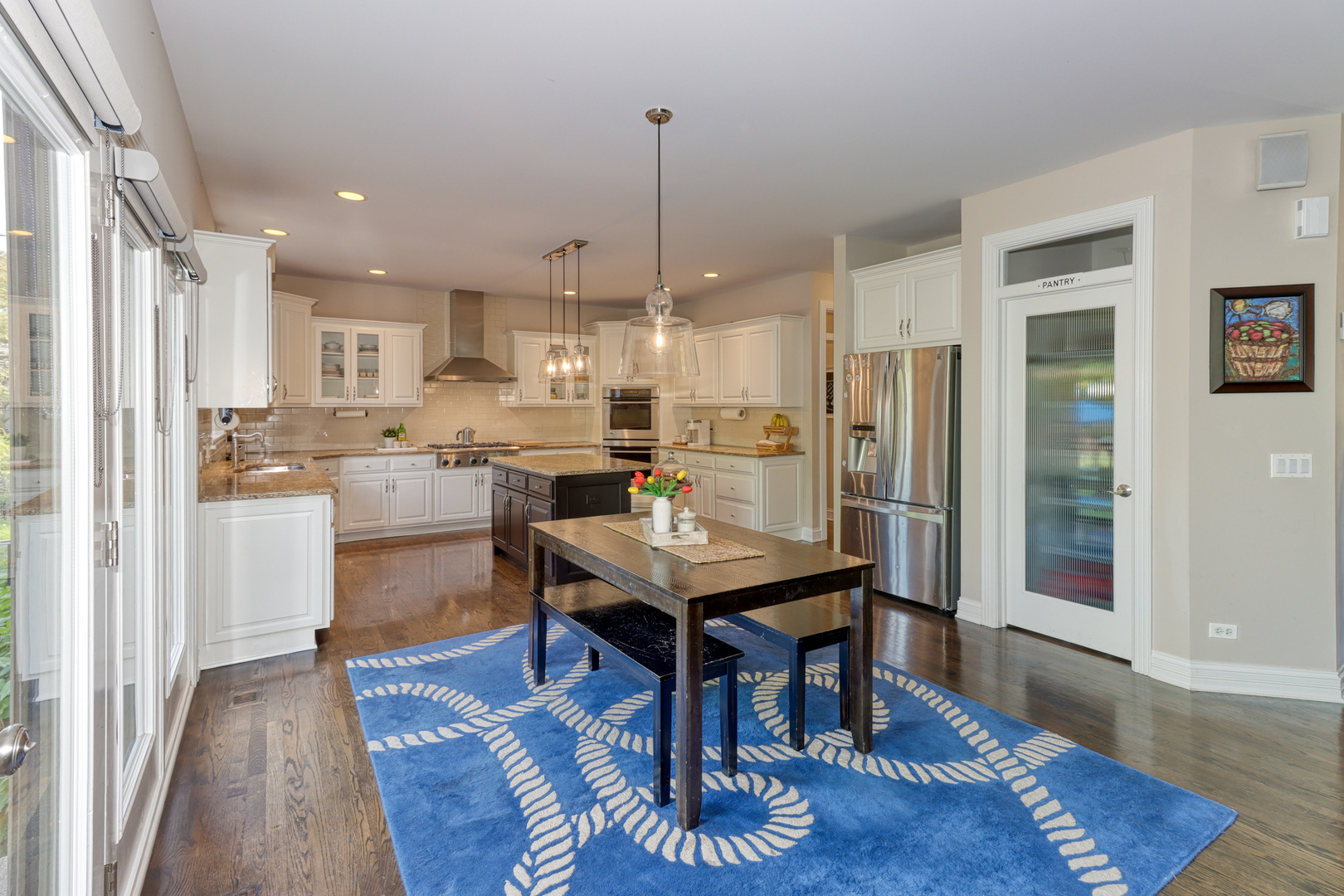 741 Merrill New Road Sugar Grove, IL 60554 - Photo 13 of 42 a room with stainless steel appliances kitchen island granite countertop furniture wooden floor and a view of kitchen