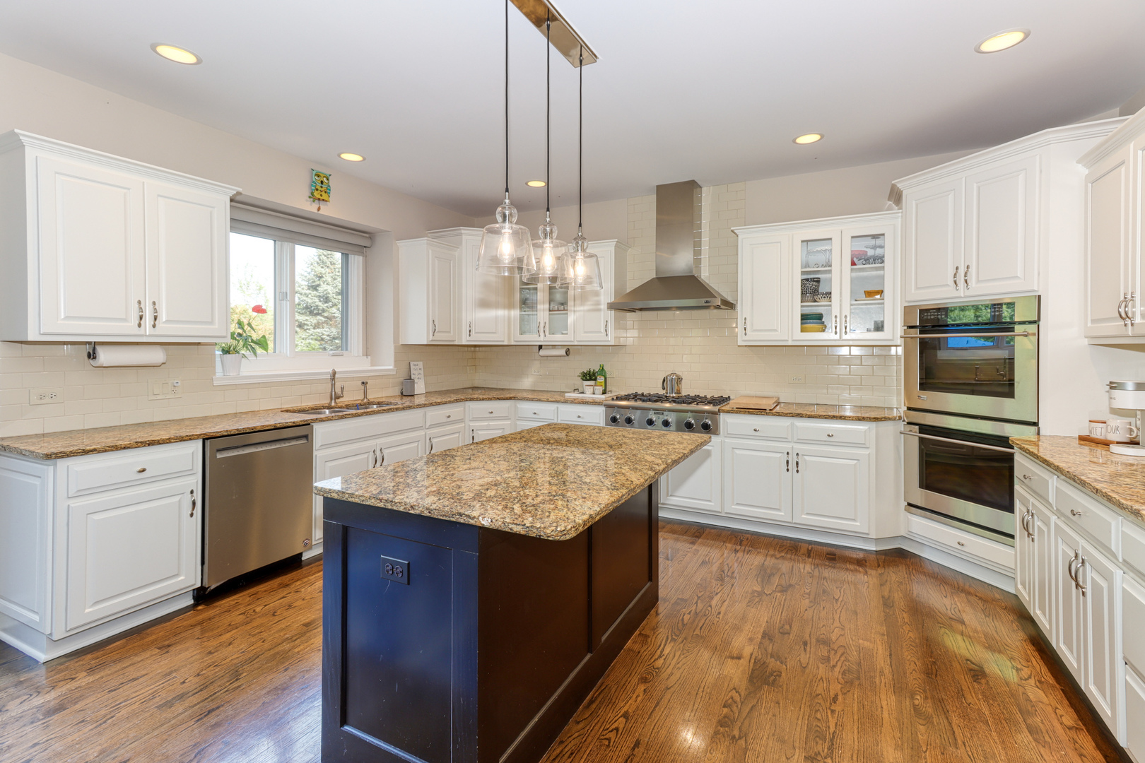 741 Merrill New Road Sugar Grove, IL 60554 - Photo 14 of 42 a kitchen with stainless steel appliances granite countertop a sink a stove top oven a refrigerator a center island and wooden floor