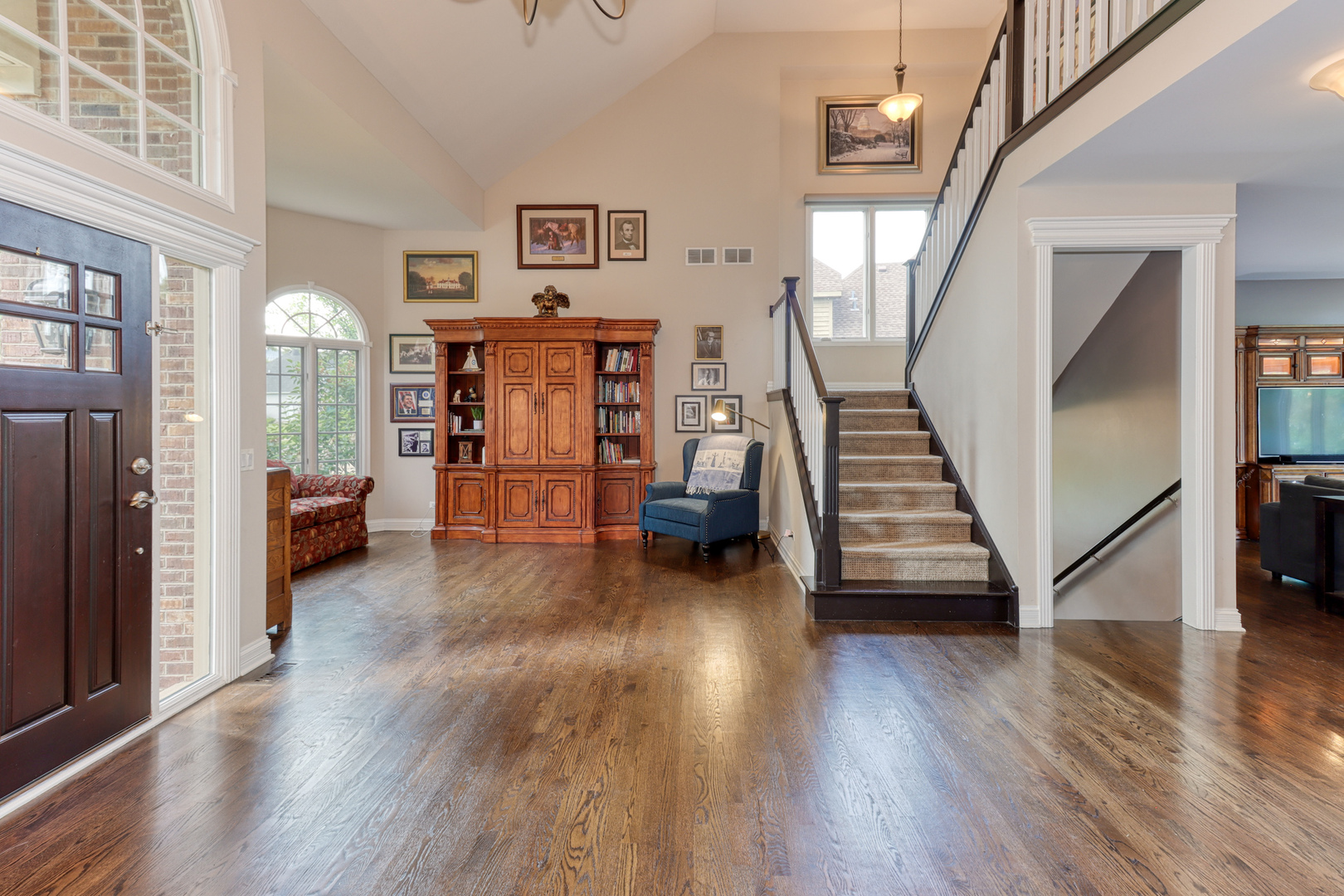 741 Merrill New Road Sugar Grove, IL 60554 - Photo 4 of 42 a view of a livingroom with wooden floor and stairs