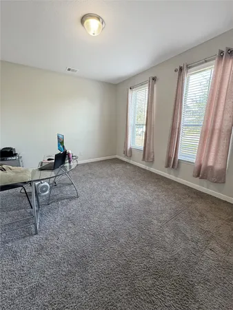 a view of empty room with windows