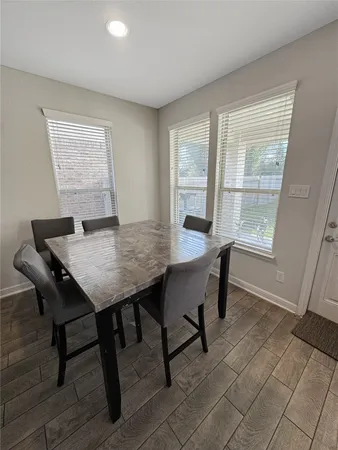 a view of a dining room with furniture and wooden floor