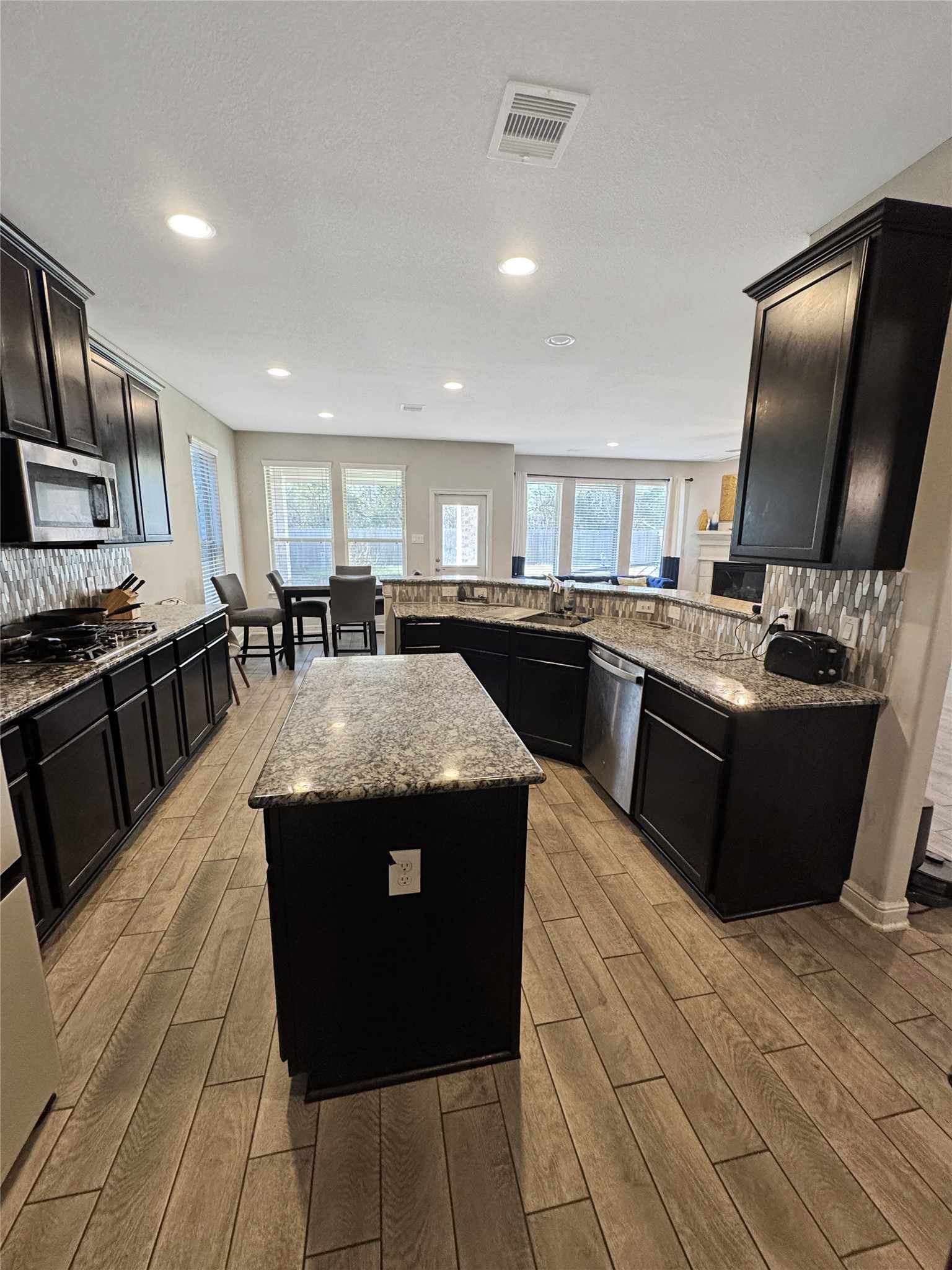 4922 Lacebark Pne Trail Rosenberg, TX 77471 - Photo 17 of 22 a kitchen with stainless steel appliances granite countertop a stove a sink and a microwave