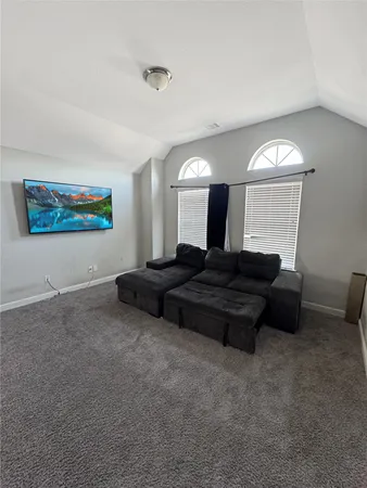 a living room with a couch a window and a fireplace