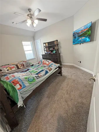 a bedroom that has a bed and a table in it