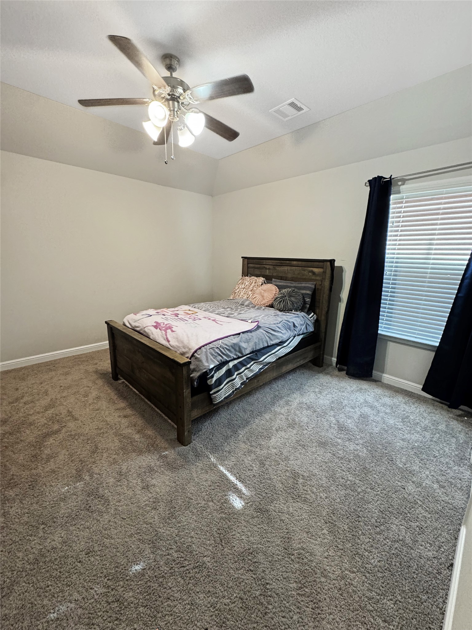 4922 Lacebark Pne Trail Rosenberg, TX 77471 - Photo 7 of 22 a bedroom with a bed and a chandelier
