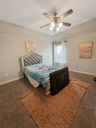 a living room with a bed furniture and a chandelier