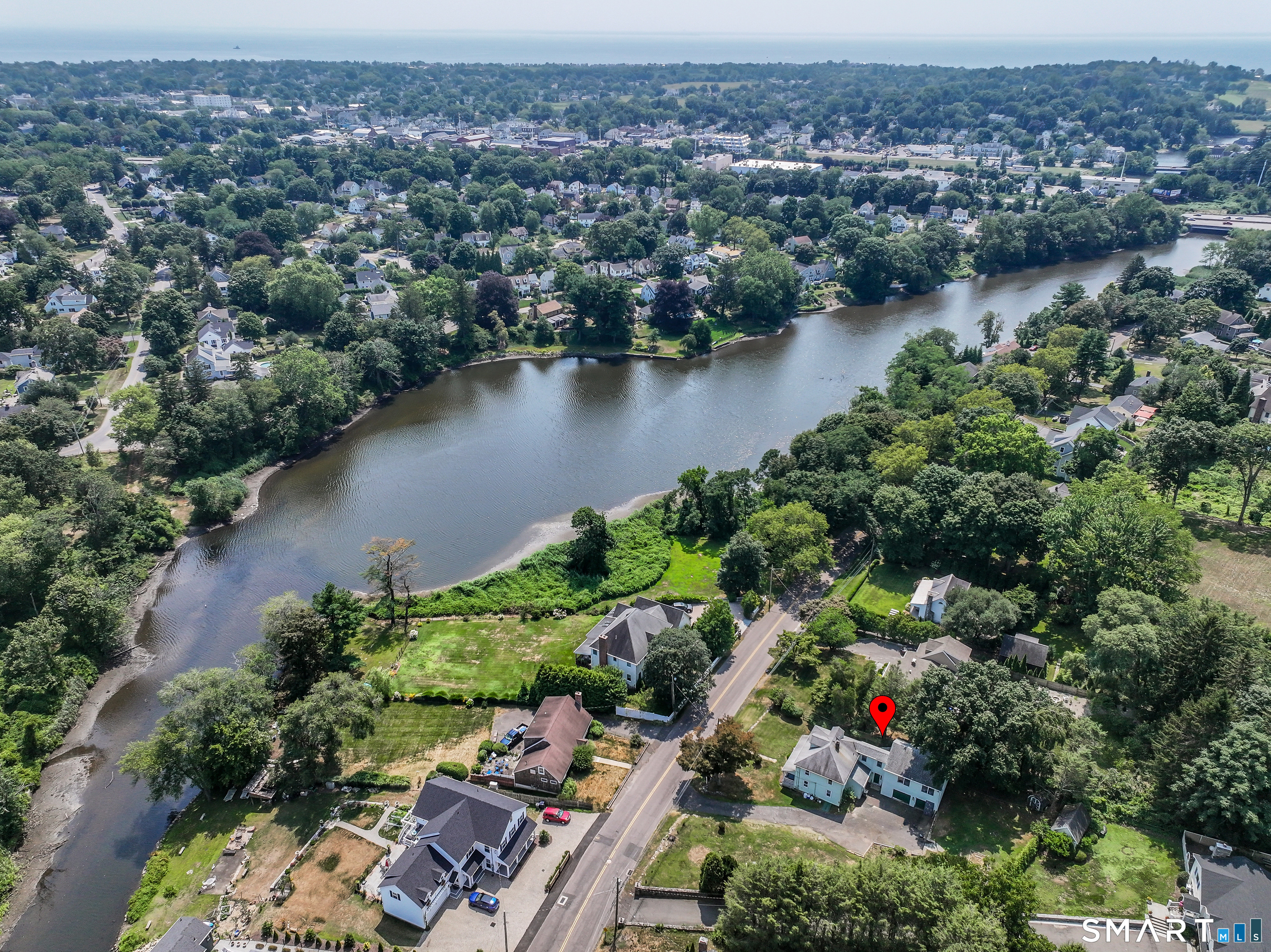 647 Bronson Road Fairfield, CT 06890 - Photo 1 of 21 an aerial view of residential house with outdoor space and lake view