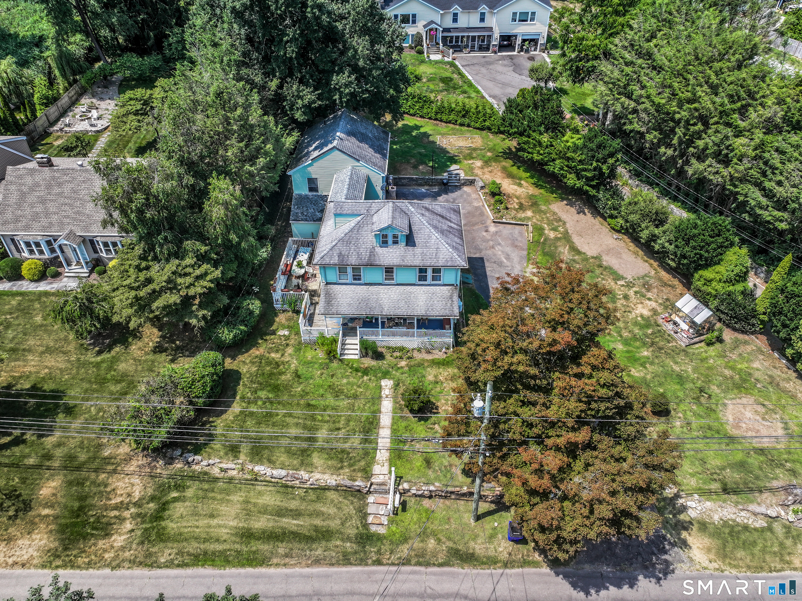 647 Bronson Road Fairfield, CT 06890 - Photo 3 of 21 an aerial view of a house with a yard
