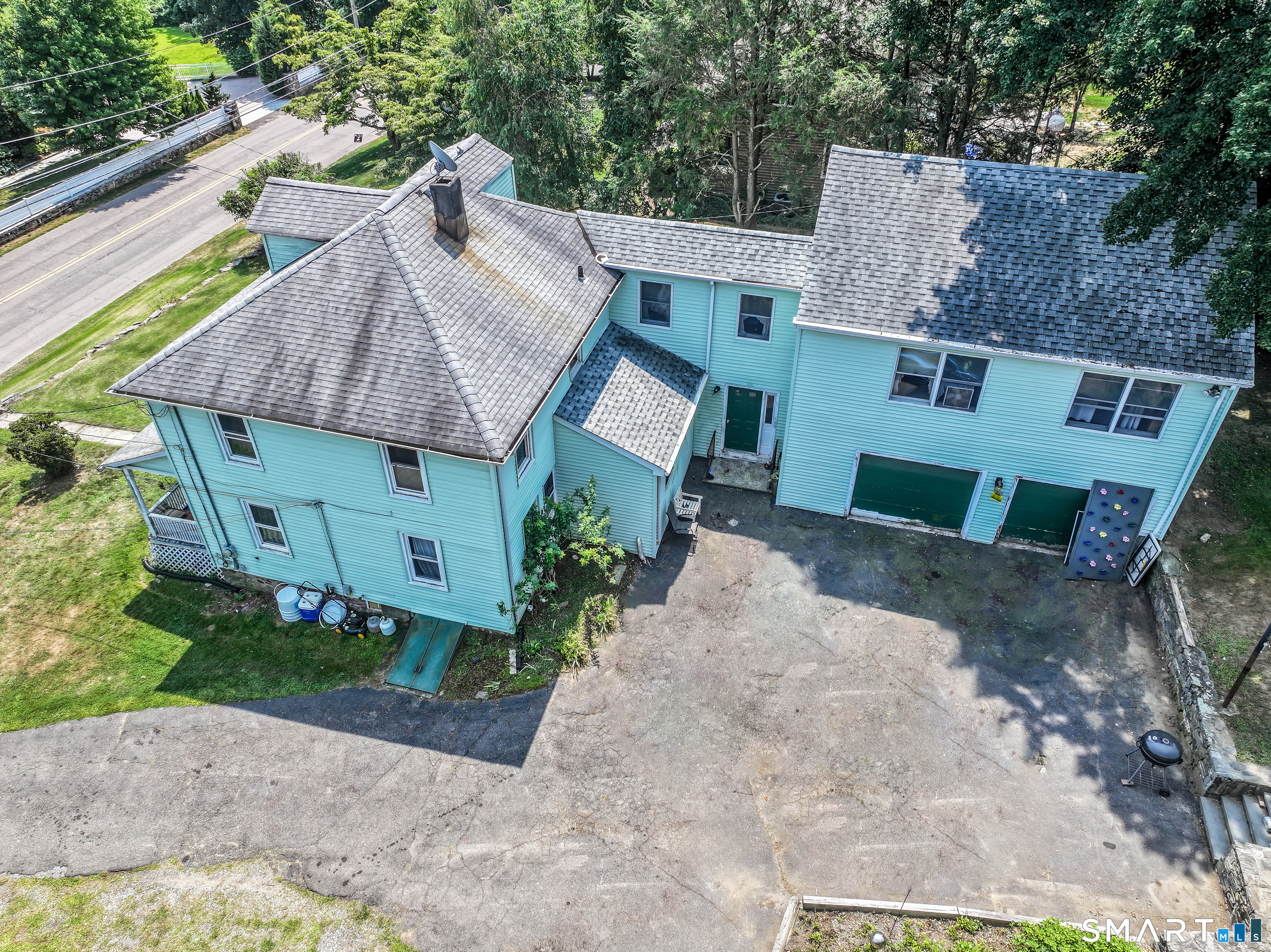 647 Bronson Road Fairfield, CT 06890 - Photo 6 of 21 an aerial view of a house with a yard and outdoor seating