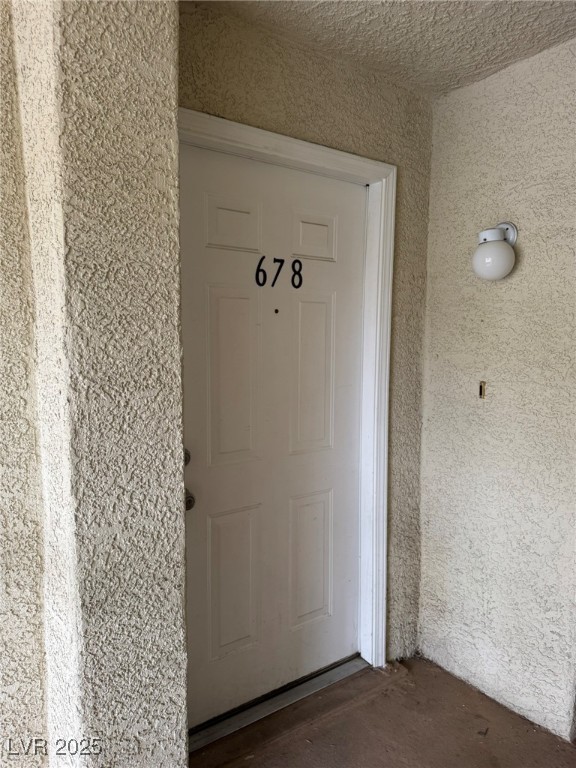 678 Anne Lane, Unit 678 Henderson, NV 89015 - Photo 2 of 14 Doorway to property featuring stucco siding