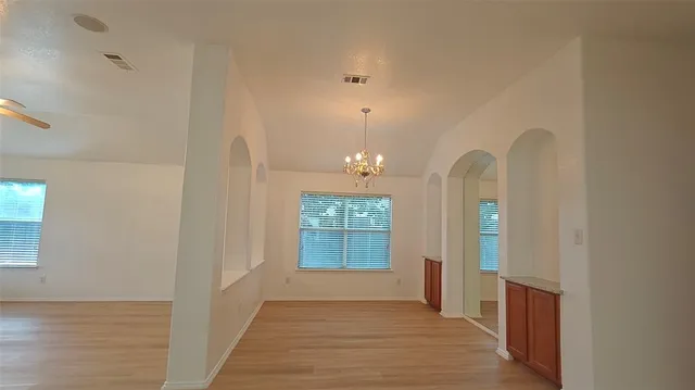 a view of a room with wooden floor and window