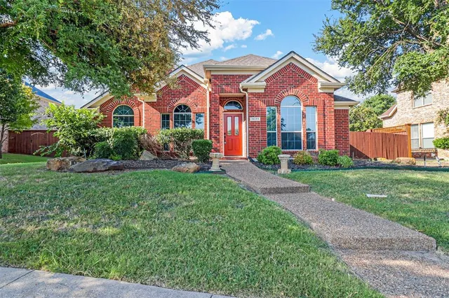 a front view of a house with a yard and porch
