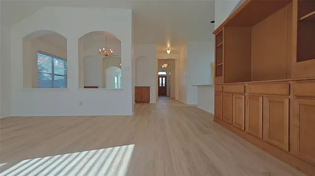 a view of a livingroom with wooden floor and staircase