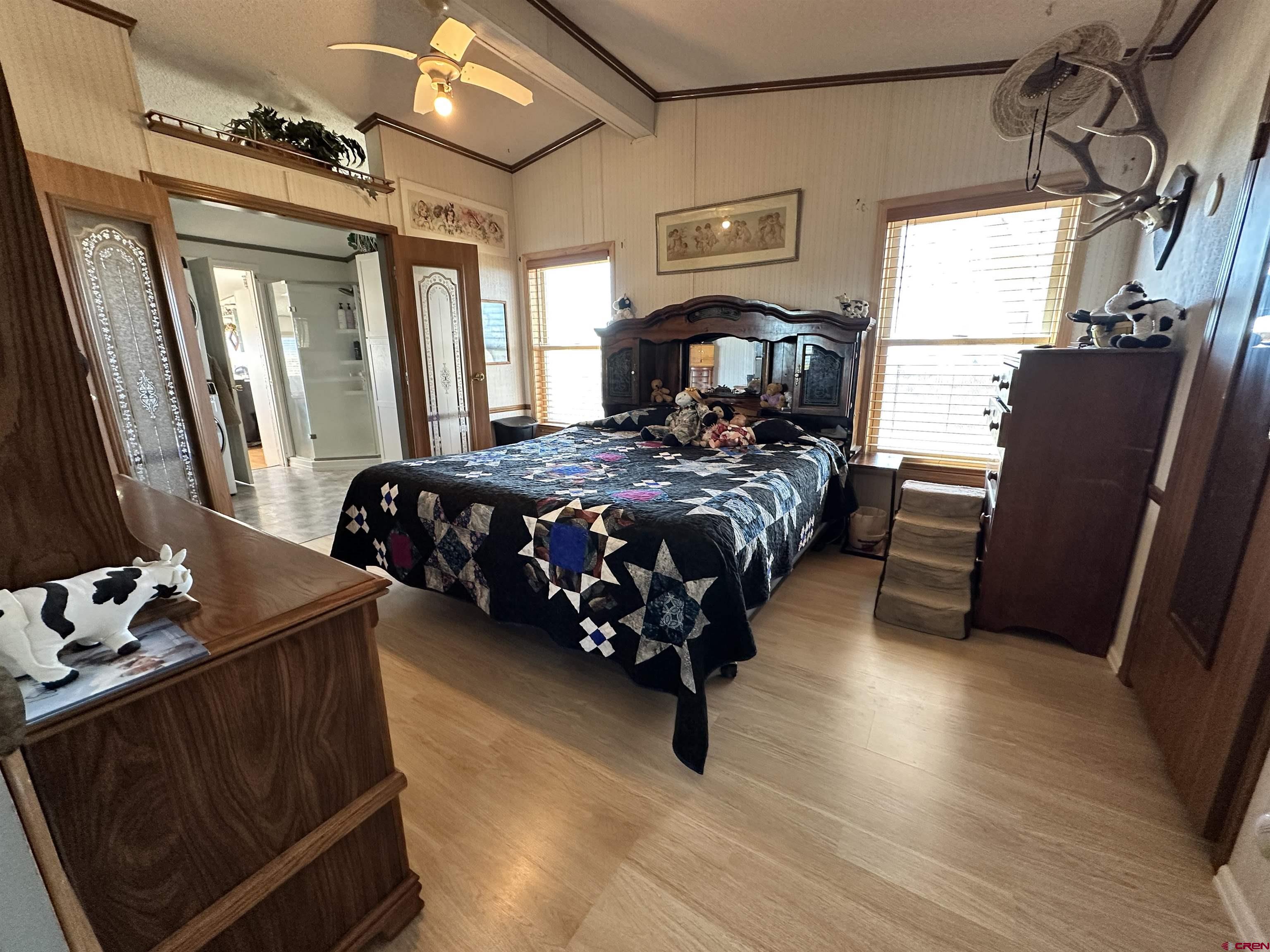 12880 2900th Road Hotchkiss, CO 81419 - Photo 9 of 22 a bed sitting in a bedroom next to a window
