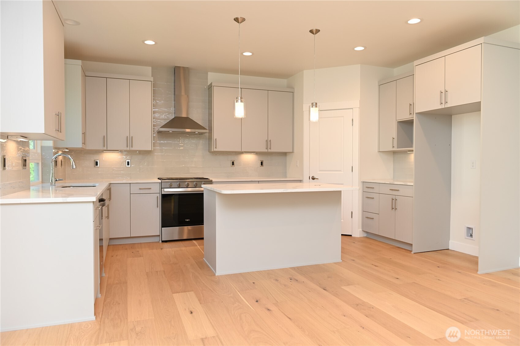 1323 Roland Street Bellingham, WA 98229 - Photo 10 of 16 a kitchen with a sink white cabinets and stainless steel appliances