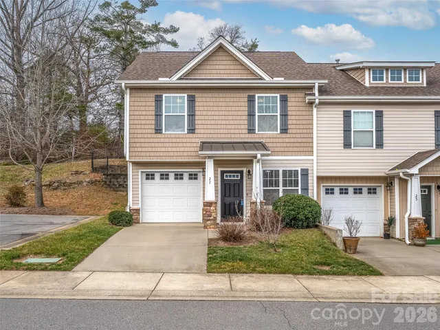 a front view of a house with a yard and a garage