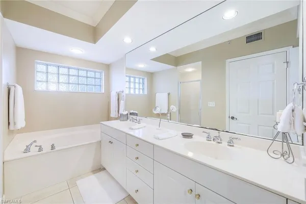 a bathroom with a double vanity sink mirror and double