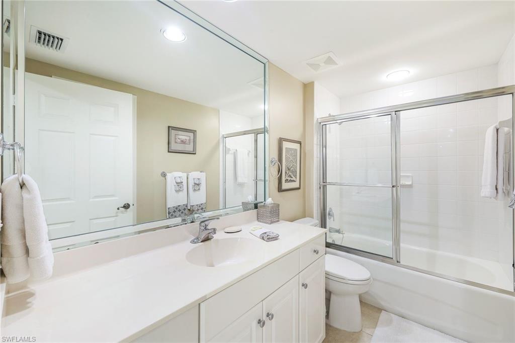 325 Dunes Boulevard, Unit 406 Naples, FL 34110 - Photo 16 of 21 a bathroom with a sink a toilet and shower