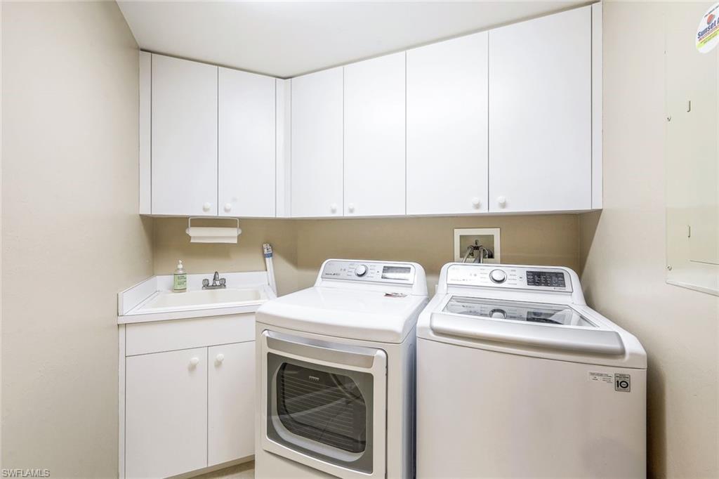325 Dunes Boulevard, Unit 406 Naples, FL 34110 - Photo 17 of 21 a utility room with dryer and washer