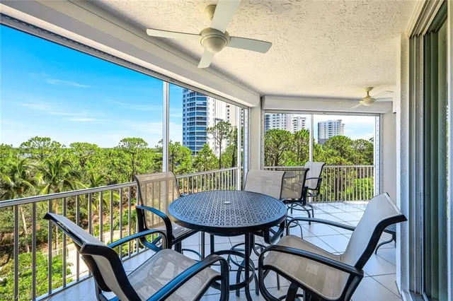 a view of a chairs and table in the balcony
