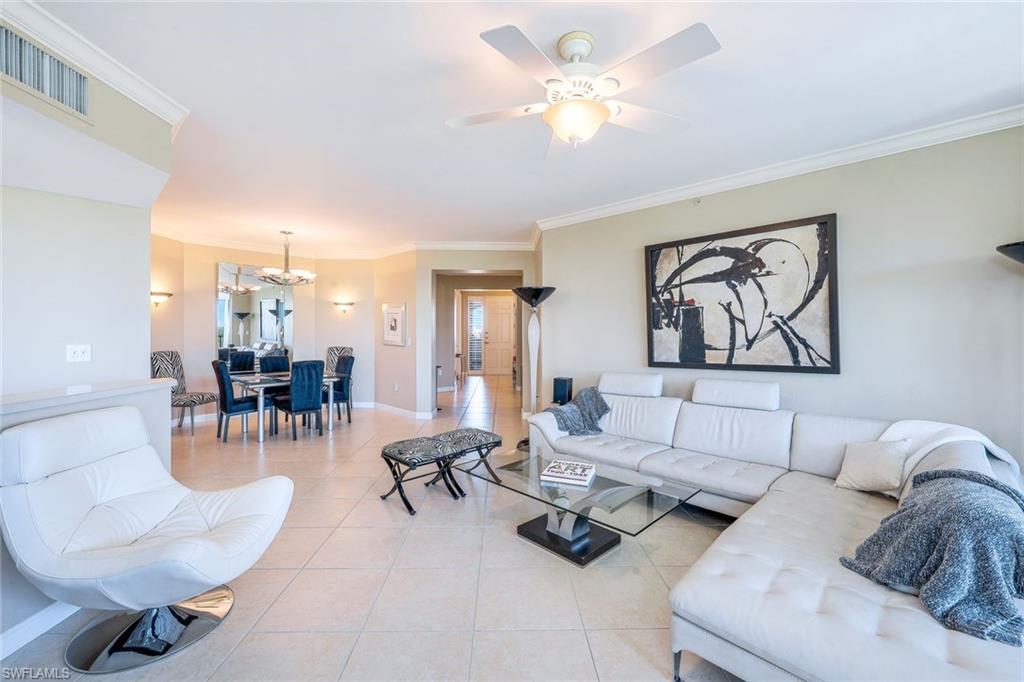 325 Dunes Boulevard, Unit 406 Naples, FL 34110 - Photo 3 of 21 a living room with furniture a dining table and a piano
