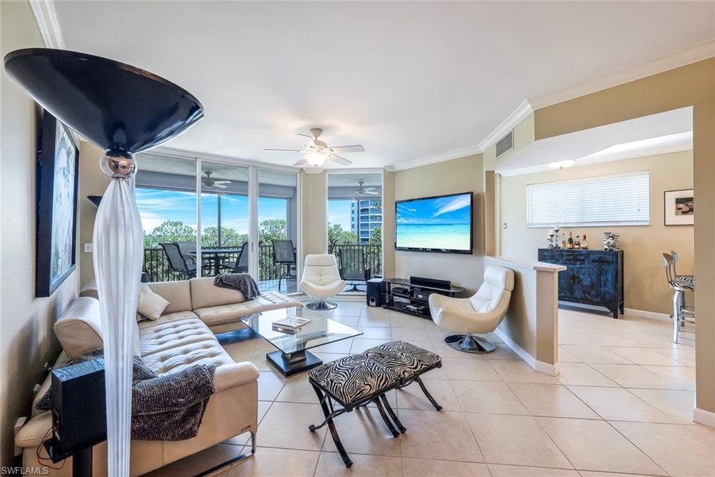 325 Dunes Boulevard, Unit 406 Naples, FL 34110 - Photo 4 of 21 a living room with furniture and a large window