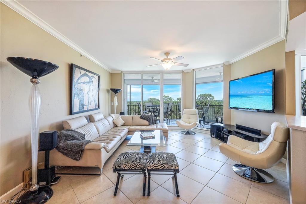 325 Dunes Boulevard, Unit 406 Naples, FL 34110 - Photo 5 of 21 a living room with furniture and a large window