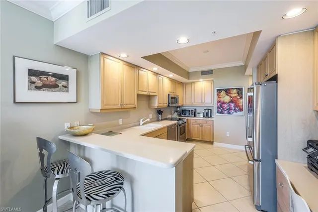 a kitchen that has a sink and a stove in it