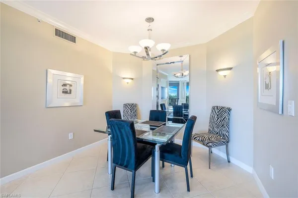 a view of a dining room with furniture and a chandelier fan