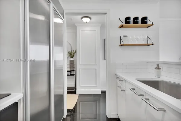 a kitchen with a sink and a refrigerator