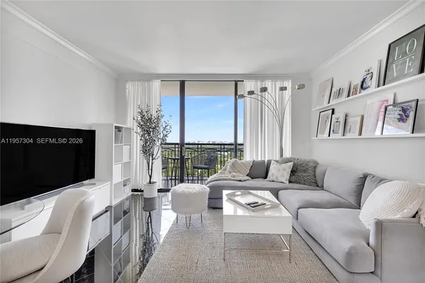 a living room with furniture large window and a flat screen tv